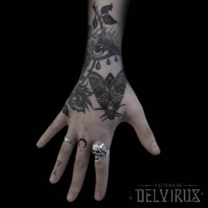 blackwork moth on hand tattoo